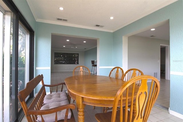 tiled dining room with ornamental molding