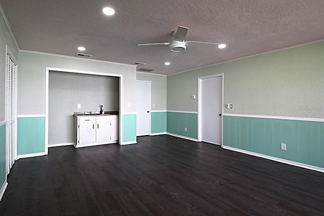 interior space with crown molding, sink, dark wood-type flooring, ceiling fan, and a textured ceiling