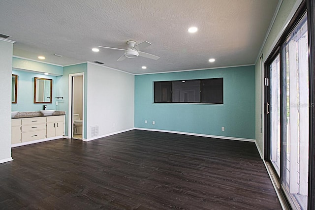 unfurnished living room with ceiling fan, dark hardwood / wood-style floors, and crown molding