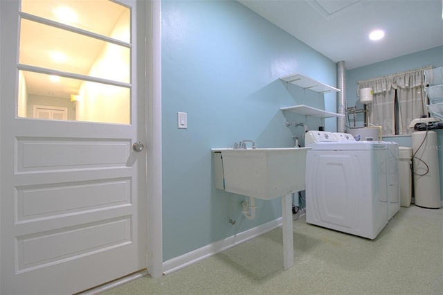 washroom with washer / dryer, light colored carpet, and sink