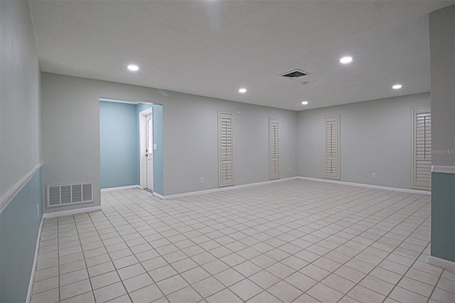 unfurnished room featuring light tile patterned floors