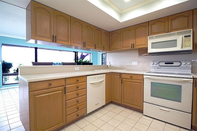 kitchen with ornamental molding, white appliances, plenty of natural light, and sink