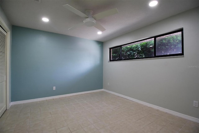 spare room with a wealth of natural light and ceiling fan