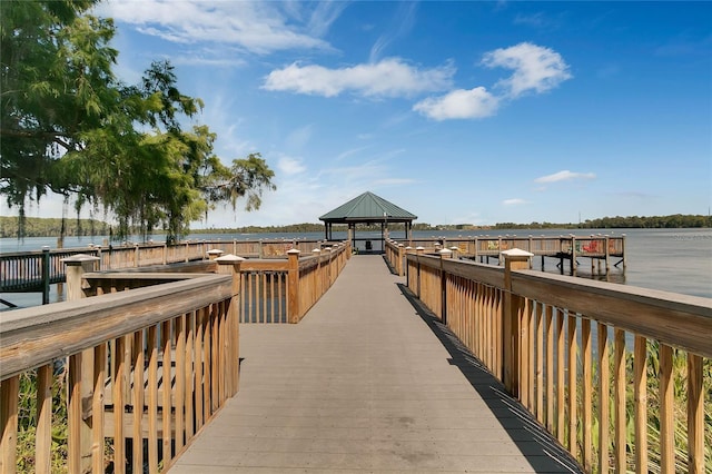 view of dock featuring a gazebo and a water view