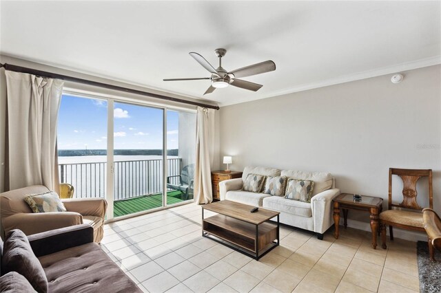 tiled living room with a water view, ceiling fan, and crown molding