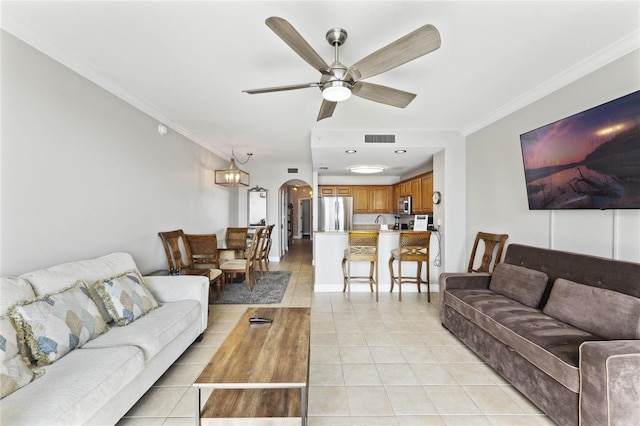 living room featuring crown molding, light tile patterned floors, and ceiling fan