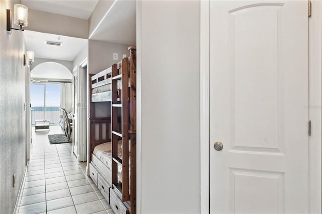 hall featuring light tile patterned floors