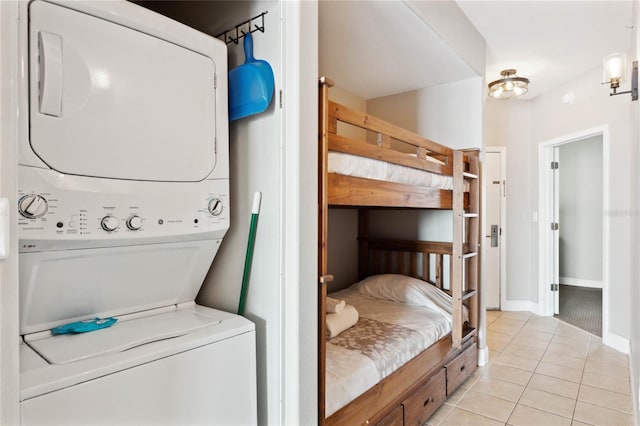 interior space featuring stacked washer and clothes dryer and light tile patterned floors