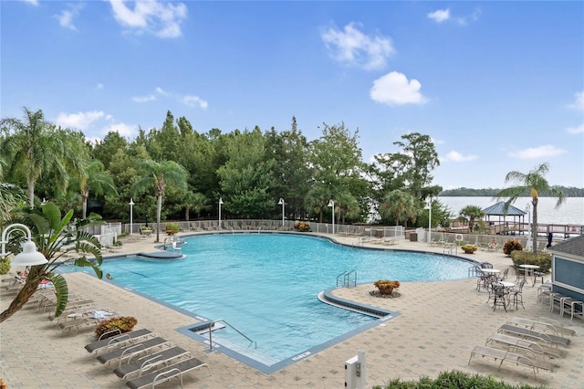 view of swimming pool with a gazebo, a water view, and a patio