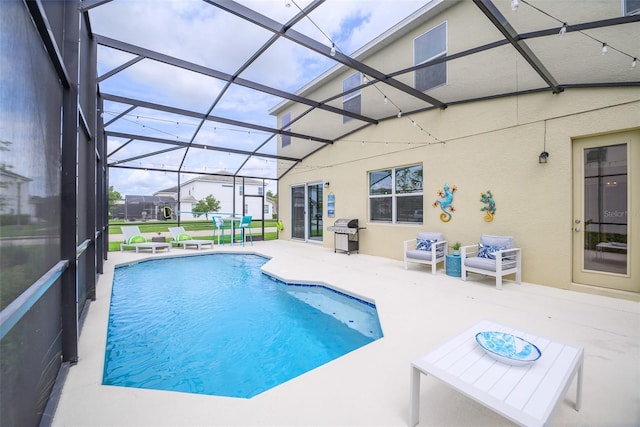 pool with glass enclosure, a patio area, and area for grilling