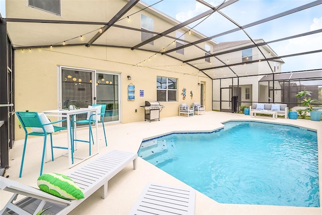 pool featuring a lanai, a patio, and an outdoor hangout area