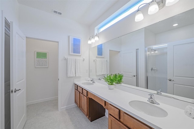 bathroom featuring visible vents, a sink, a shower stall, and double vanity