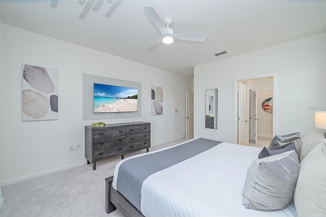 bedroom featuring a walk in closet, light colored carpet, visible vents, a ceiling fan, and baseboards