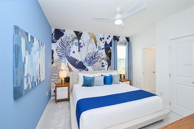 bedroom with baseboards, ceiling fan, and light colored carpet