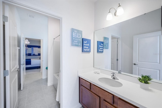 ensuite bathroom with tile patterned flooring, visible vents, connected bathroom, and vanity