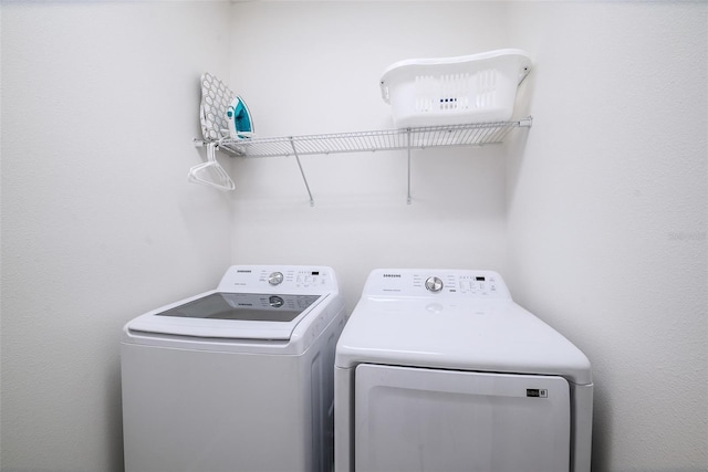 washroom featuring washer and dryer and laundry area