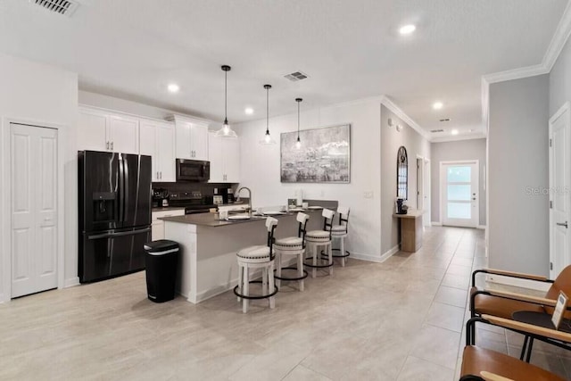 kitchen with black appliances, crown molding, white cabinetry, and a center island with sink