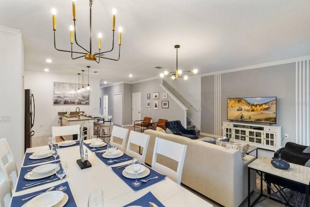 dining area featuring crown molding, sink, and an inviting chandelier