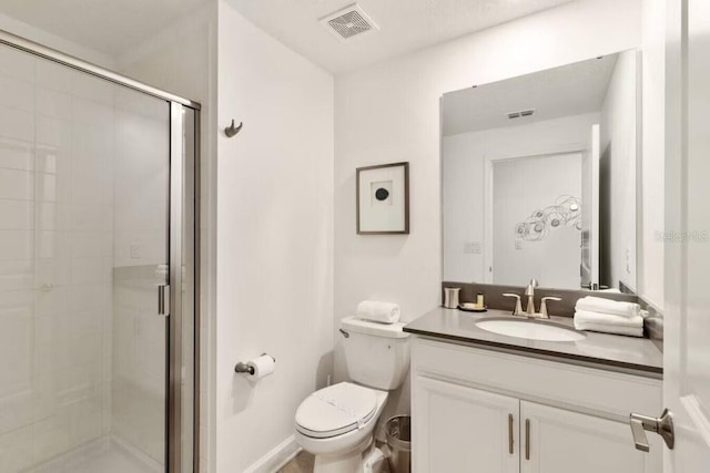 bathroom with vanity, walk in shower, and toilet