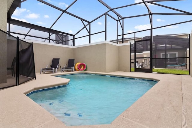 view of pool with a patio and a lanai