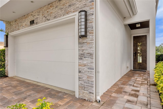 doorway to property with a garage