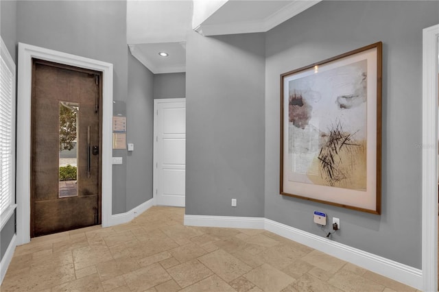 tiled entrance foyer featuring crown molding