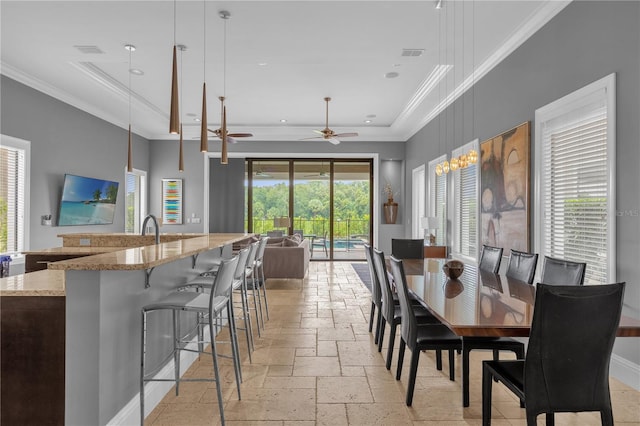 dining space featuring ceiling fan, light tile patterned flooring, and a tray ceiling