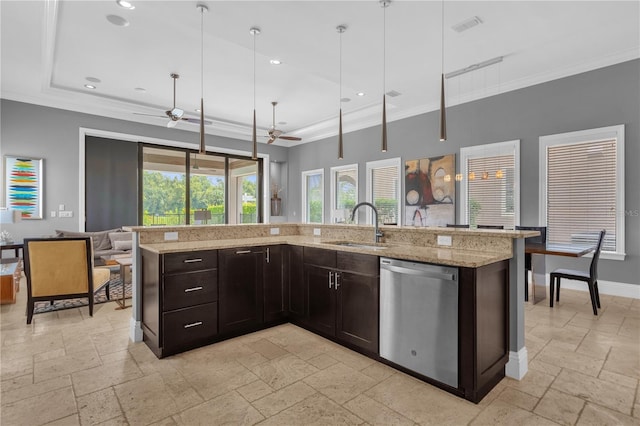 kitchen featuring sink, decorative light fixtures, stainless steel dishwasher, and an island with sink