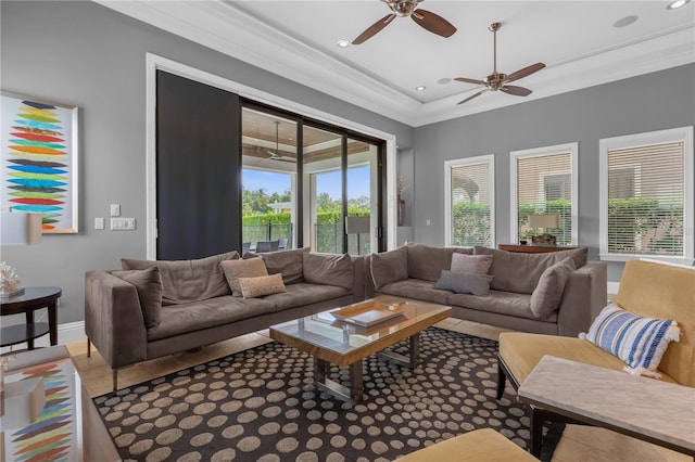 living room with ceiling fan and crown molding