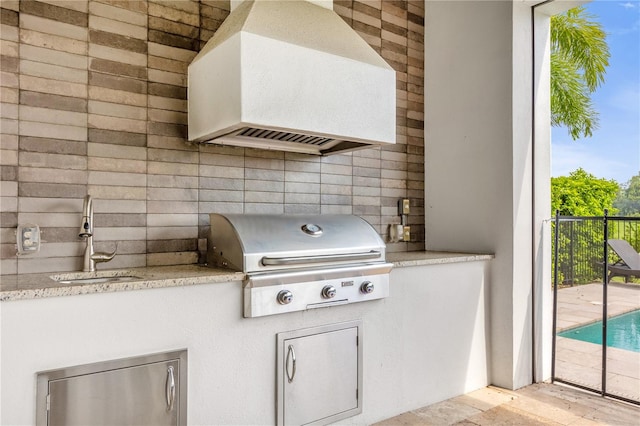 view of patio featuring a grill and sink