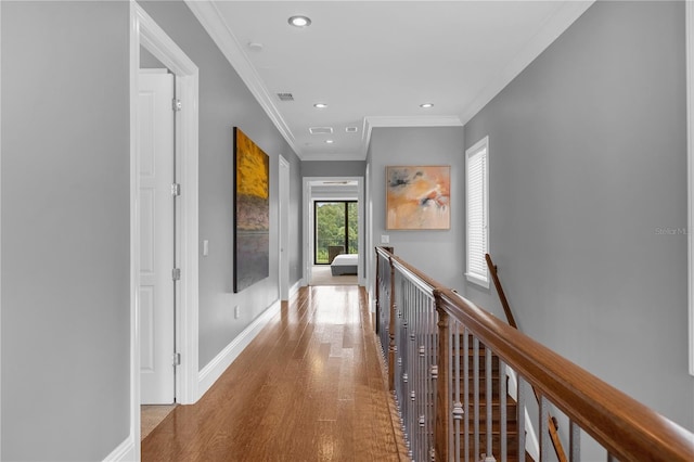 corridor featuring hardwood / wood-style flooring and crown molding