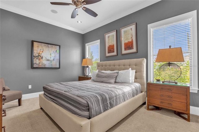 carpeted bedroom featuring ceiling fan and crown molding