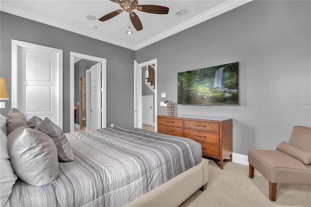 carpeted bedroom with ceiling fan and crown molding