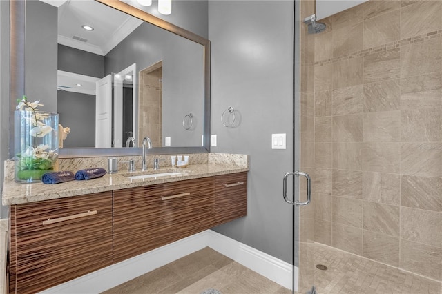 bathroom featuring a shower with door, ornamental molding, vanity, and tile patterned floors