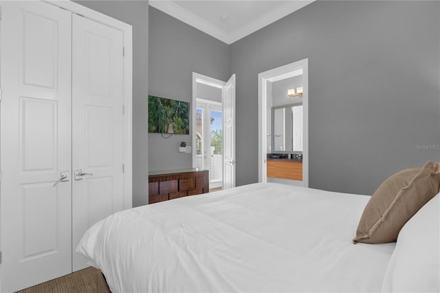 bedroom featuring crown molding and a closet