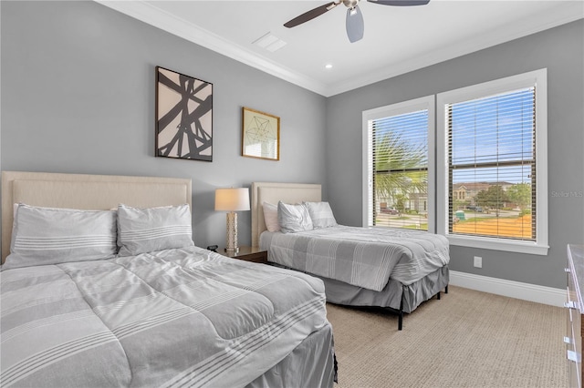 carpeted bedroom featuring ceiling fan and crown molding