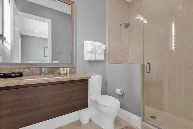 bathroom with toilet, ornamental molding, vanity, and an enclosed shower