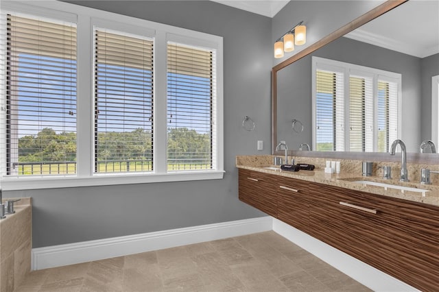 bathroom with crown molding, plenty of natural light, and vanity