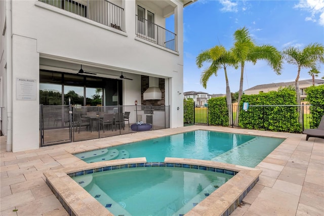 view of pool featuring an in ground hot tub