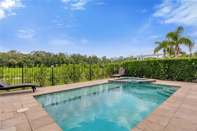 view of swimming pool with an in ground hot tub