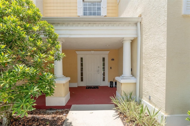 entrance to property featuring stucco siding