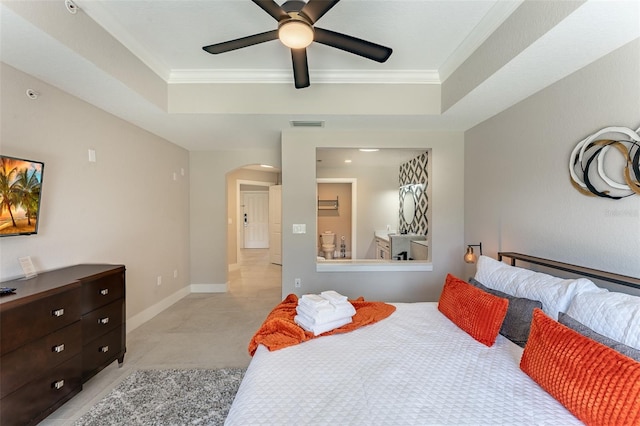 tiled bedroom with ceiling fan, a raised ceiling, and ornamental molding