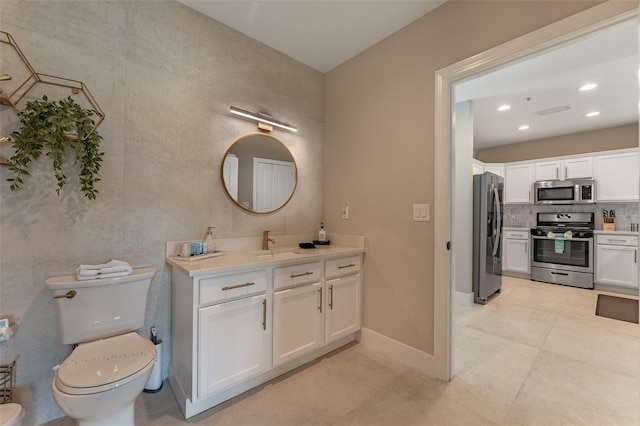 bathroom with vanity, decorative backsplash, toilet, and tile patterned flooring