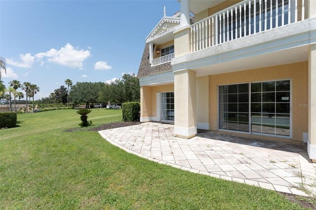 view of yard with a patio area and a balcony