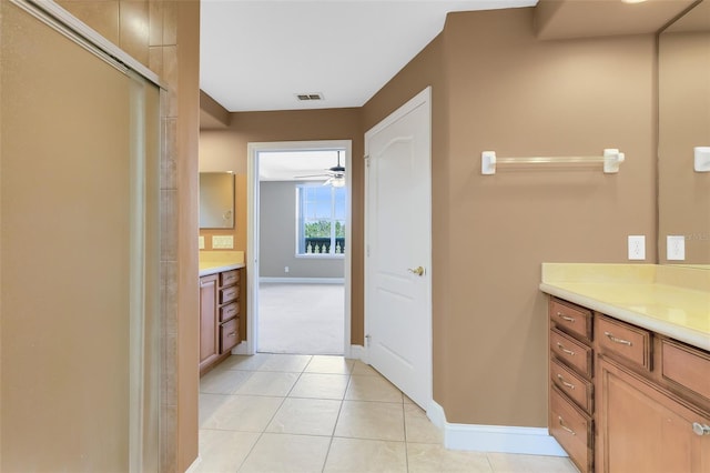 bathroom featuring tile patterned floors, ceiling fan, vanity, and walk in shower