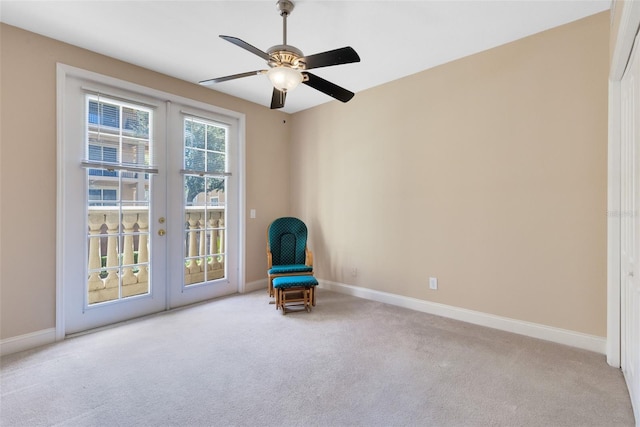 unfurnished room with french doors, light colored carpet, and ceiling fan