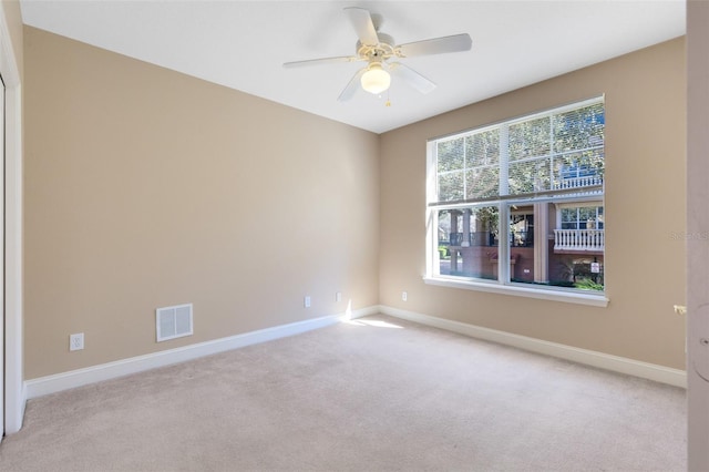 unfurnished room with light carpet and ceiling fan