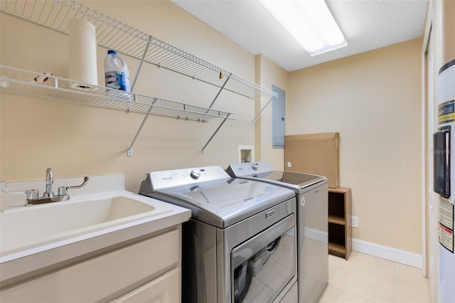 laundry room with electric panel, washing machine and clothes dryer, sink, and light tile patterned flooring