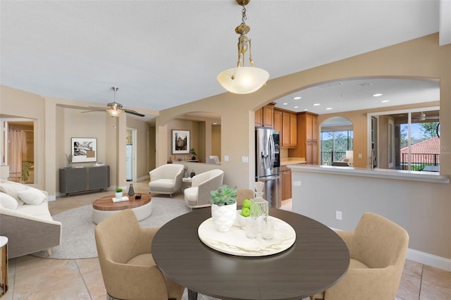 dining space featuring ceiling fan and light tile patterned floors