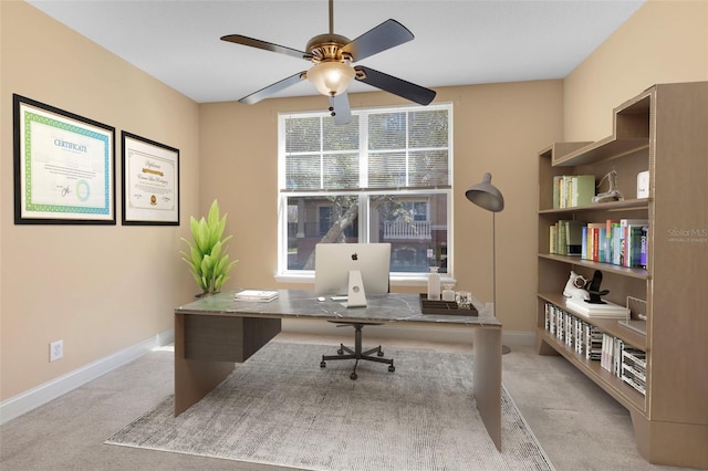 office featuring ceiling fan and light colored carpet